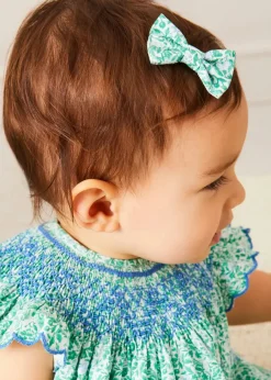 Pepa London Adelaide Floral Hand Smocked Sleeveless Dress With Bloomers in Green (3mths-3yrs) | Openwork Cotton Cardigan in Cream (6mths-10yrs) | Leather Mary Jane Pram Shoes in Ivory (17-20EU) | Adelaide Floral Small Bow Hair Clip in Green | Openwork short socks White (0mths-8yrs) | Flower Fairies of the Spring Book in White