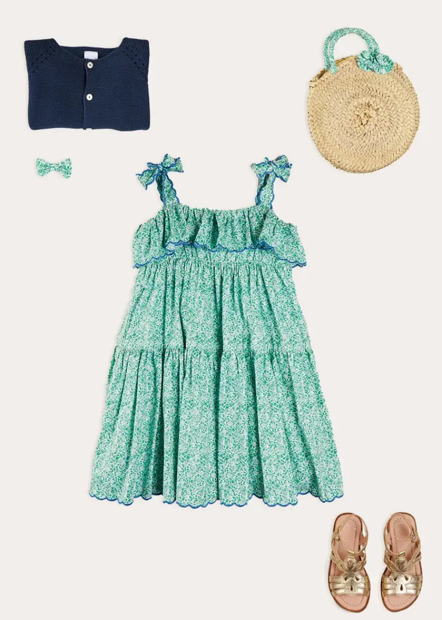 Pepa London Adelaide Floral Tiered Tie Strap Dress in Green (4-12yrs) | Plain Cardigan in Navy (6mths-10yrs) | Metallic Strappy Leather Sandals in Gold (24-35EU) | Adelaide Floral Detail Raffia Bag in Green | Adelaide Floral Small Bow Hair Clip in Green