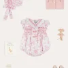 Pepa London Audrey Hand Smocked Double Breasted Short Sleeve Romper in Pink (6mths-2yrs) | Audrey Toile Hand Smocked Bonnet in Pink (S-M) | Openwork Cotton Cardigan in Pink (6mths-10yrs) | Mary Jane Pram Shoes in Pink (17-20EU) | Openwork short socks White (0mths-8yrs)