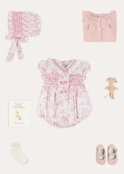 Pepa London Audrey Hand Smocked Double Breasted Short Sleeve Romper in Pink (6mths-2yrs) | Audrey Toile Hand Smocked Bonnet in Pink (S-M) | Openwork Cotton Cardigan in Pink (6mths-10yrs) | Mary Jane Pram Shoes in Pink (17-20EU) | Openwork short socks White (0mths-8yrs)