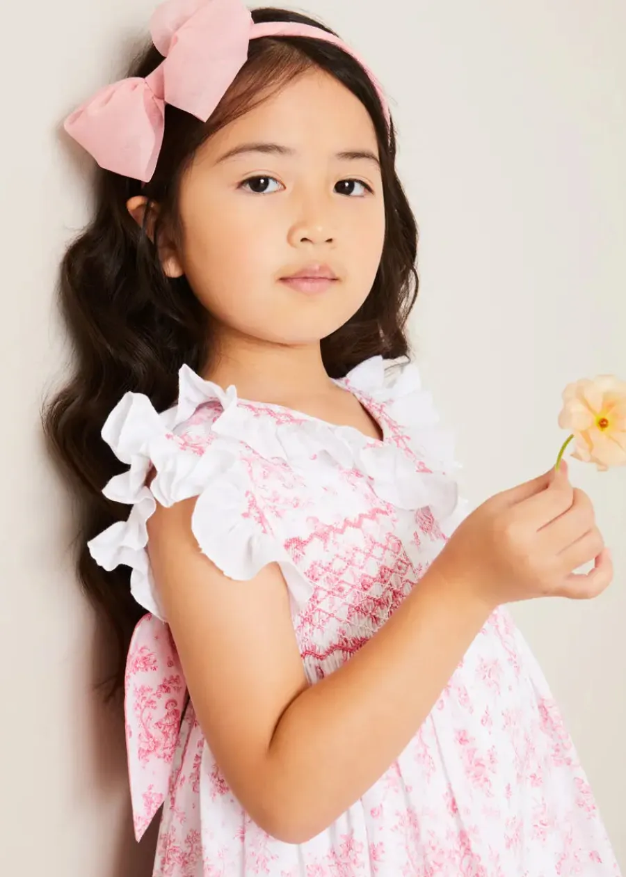 Pepa London Audrey Toile Hand Smocked Double Breasted Sleeveless Dress in Pink (12mths-10yrs) | Peter Pan Collar Swing Coat in Pink (18mths-10yrs) | Openwork Cotton Cardigan in Cream (6mths-10yrs) | Leather Mary Jane Shoes in Pink (24-34EU) | Traditional Big Bow Tulle Hairband in Dusty Pink | Openwork short socks White (0mths-8yrs)