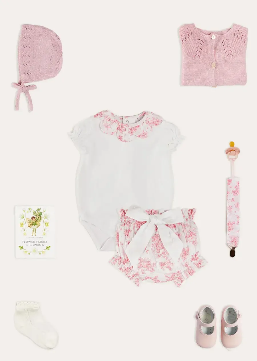 Pepa London Audrey Toile Scallop Collar Short Sleeve Bodysuit in Pink (1mth-2yrs) | Audrey Toile Bow Detail Bloomers in Pink (1mth-2yrs) | Openwork Cotton Cardigan in Pink (6mths-10yrs) | Openwork Cotton Knitted Bonnet in Pink (S-L) | Mary Jane Pram Shoes in Pink (17-20EU) | Audrey Toile Dummy Clip in Pink | Openwork short socks White (0mths-8yrs) | BIBS Dummy in Pink