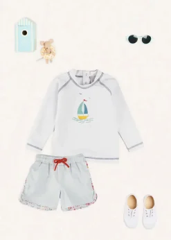 BOY Pepa London Boat Motif Long Sleeve Rashguard in Blue (2-6yrs) | Striped Contrast Trim Swim Shorts in Blue (2-10yrs) | Canvas Plimsolls in White (20-34EU) | Little Brother Beach Mouse Toy
