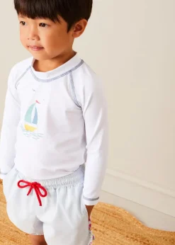 BOY Pepa London Boat Motif Long Sleeve Rashguard in Blue (2-6yrs) | Striped Contrast Trim Swim Shorts in Blue (2-10yrs) | Canvas Plimsolls in White (20-34EU) | Little Brother Beach Mouse Toy