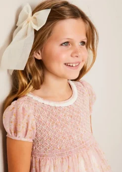 Pepa London Constance Floral Hand Smocked Short Sleeve Party Dress in Pink (12mths-10yrs) | Openwork Cotton Cardigan in Cream (6mths-10yrs) | Leather Charlotte Shoes in Gold (24-35EU) | Tulle Long Bow Clip In Cream | Celebration Short Socks with Ruffle- Cream (0mths-10yrs)