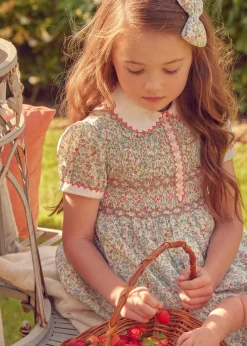 Pepa London Cordelia Floral Hand-Smocked Short Sleeve Dress in Pink Made with Liberty Fabric (12m-6yrs) | Openwork Cotton Cardigan in Pink (6mths-10yrs) | Leather Mary Jane Shoes in Pink (24-34EU) | Cordelia Floral Medium Bow Clip in Pink Made with Liberty Fabric | Celebration Short Socks with ruffle - Sand (0mths-10yrs)