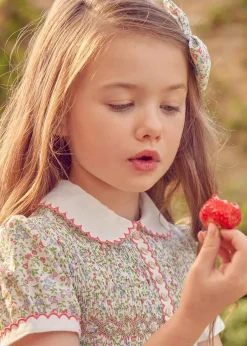 Pepa London Cordelia Floral Hand-Smocked Short Sleeve Dress in Pink Made with Liberty Fabric (12m-6yrs) | Openwork Cotton Cardigan in Pink (6mths-10yrs) | Leather Mary Jane Shoes in Pink (24-34EU) | Cordelia Floral Medium Bow Clip in Pink Made with Liberty Fabric | Celebration Short Socks with ruffle - Sand (0mths-10yrs)