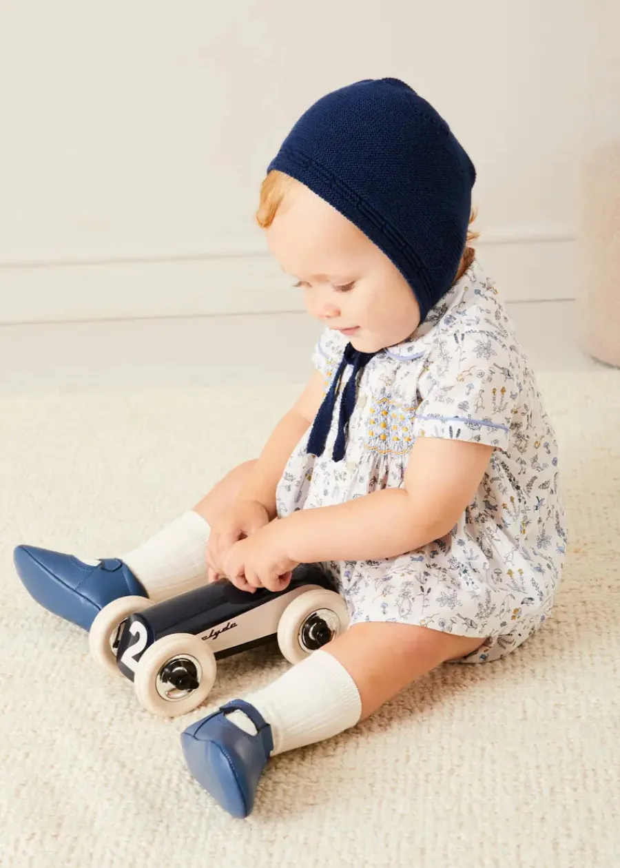 BOY Pepa London Ellis Liberty Print Hand Smocked Short Sleeve Shirt in Blue (6mths-4yrs) | Ellis Floral Bloomer in Blue Made with Liberty Fabric (1m-3yrs) | Plain Cardigan in Navy (6mths-10yrs) | Openwork Knitted Bonnet in Navy (S-L) | Leather T-Bar Pram Shoes in Classic Blue (17-20EU) | Ribbed Short Socks - Cream (0mths-10yrs)
