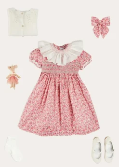 Pepa London Emilia Floral Hand Smocked Ruffle Collar Short Sleeve Dress in Pink (12mths-10yrs) | Openwork Cotton Cardigan in Cream (6mths-10yrs) | Girls Ivory Leather Mary Jane Shoes (20-34EU) | Emilia Floral Long Bow Hair Clip in Pink | Openwork short socks White (0mths-8yrs)