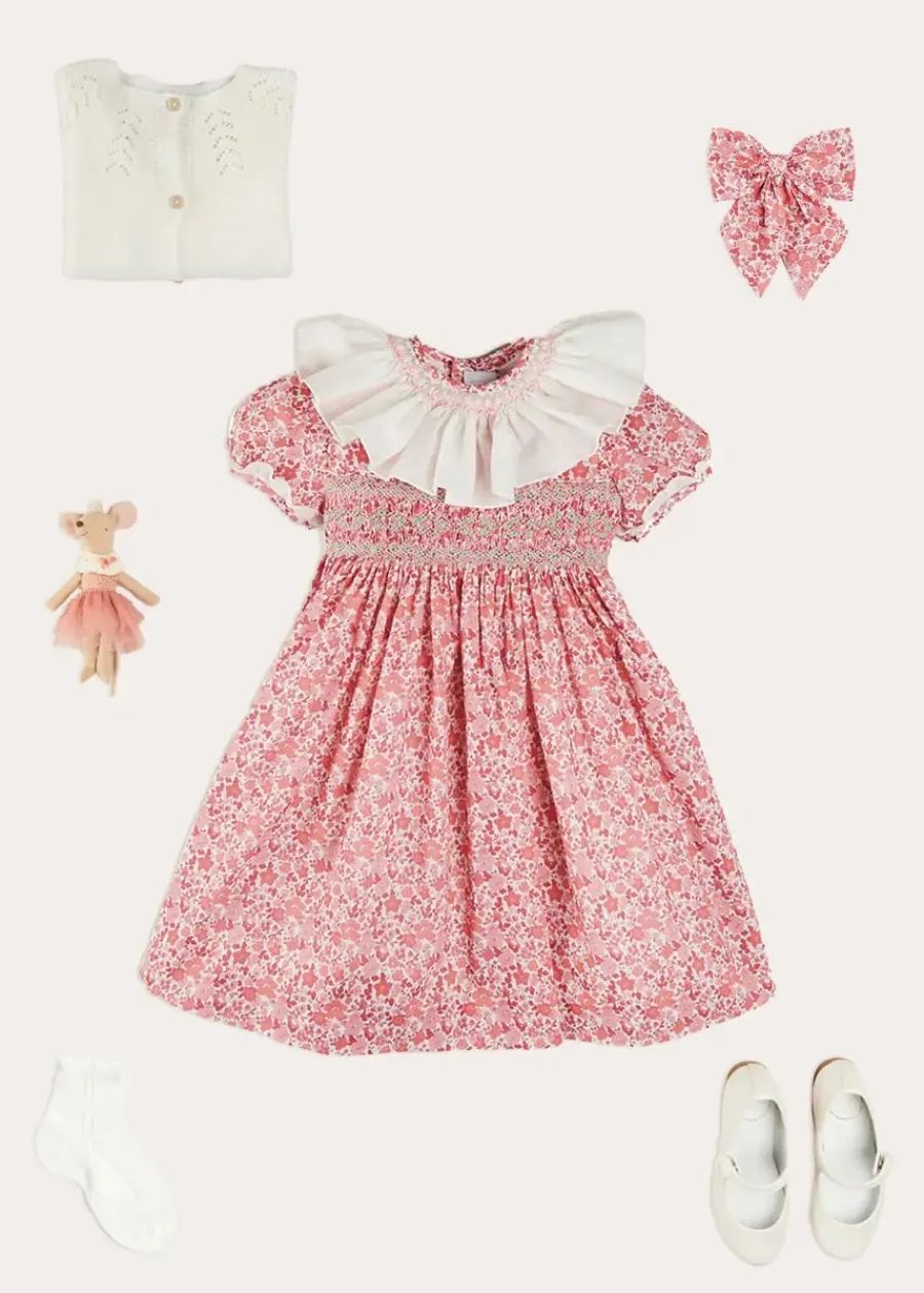 Pepa London Emilia Floral Hand Smocked Ruffle Collar Short Sleeve Dress in Pink (12mths-10yrs) | Openwork Cotton Cardigan in Cream (6mths-10yrs) | Girls Ivory Leather Mary Jane Shoes (20-34EU) | Emilia Floral Long Bow Hair Clip in Pink | Openwork short socks White (0mths-8yrs)