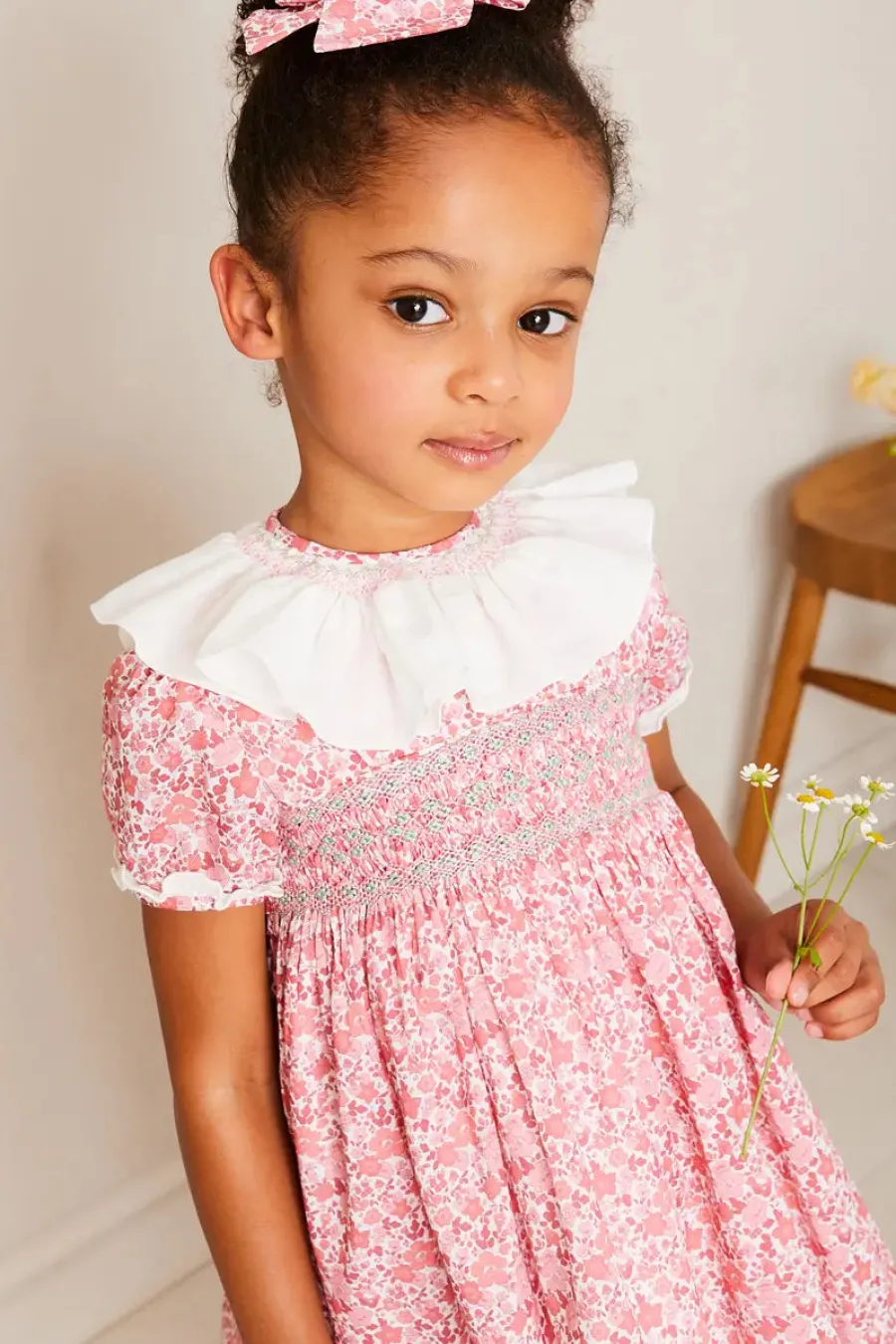Pepa London Emilia Floral Hand Smocked Ruffle Collar Short Sleeve Dress in Pink (12mths-10yrs) | Openwork Cotton Cardigan in Cream (6mths-10yrs) | Girls Ivory Leather Mary Jane Shoes (20-34EU) | Emilia Floral Long Bow Hair Clip in Pink | Openwork short socks White (0mths-8yrs)