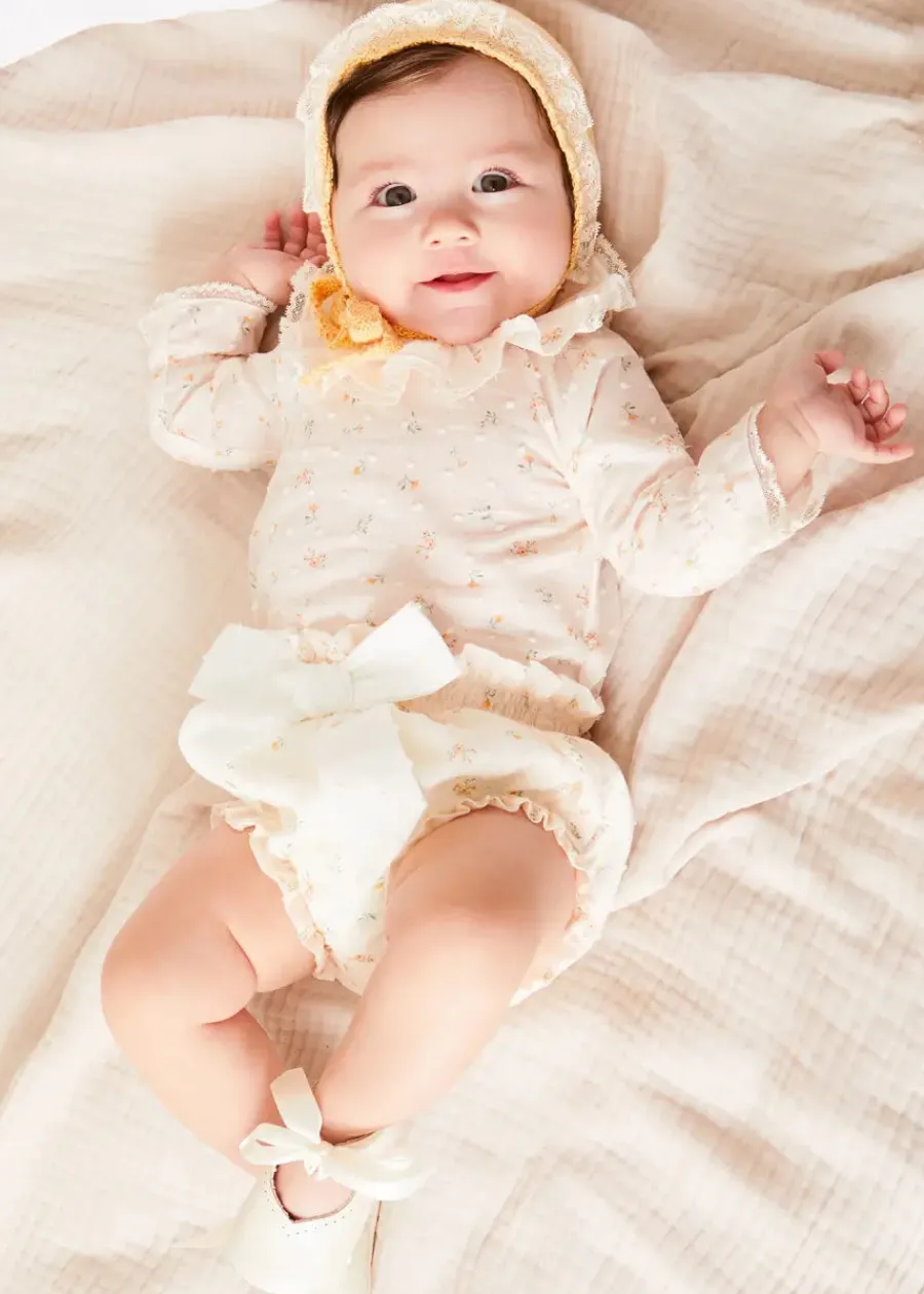 Pepa London Esme Floral Ruffle Collar Long Sleeve Blouse in White (1-12mths) | Esme Floral Bow Detail Bloomers in White (1-12mths) | Openwork Detail Cotton Baby Cardigan in Tangerine (1-12mths) | Lace Detail Knitted Bonnet in Tangerine (1-12mths) | Celebration Ribbon Detail Mary Jane Pram Shoes in Beige (17-20EU) | Esme Floral Dummy Clip in White | Little Library Book in White | White Mouse Toy