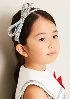 Pepa London Evelyn Floral Sleeveless Bow Detail Trapeze Dress in Red (12mths-8yrs) | Openwork Cotton Cardigan in Cream (6mths-10yrs) | Evelyn Floral Thin Bow Hairband in Red | Openwork short socks White (0mths-8yrs)