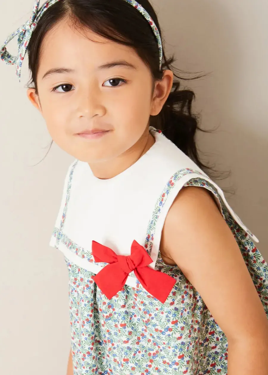 Pepa London Evelyn Floral Sleeveless Bow Detail Trapeze Dress in Red (12mths-8yrs) | Openwork Cotton Cardigan in Cream (6mths-10yrs) | Evelyn Floral Thin Bow Hairband in Red | Openwork short socks White (0mths-8yrs)