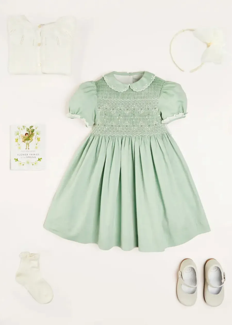 Pepa London Hand Smocked Peter Pan Collar Short Sleeve Dress in Green (12mths-10yrs) | Openwork Cotton Cardigan in Cream (6mths-10yrs) | Girls Ivory Leather Mary Jane Shoes (20-34EU) | Traditional Big Bow Tulle Hairband in Ivory | Flower Fairies of the Spring Book in White | Openwork short socks White (0mths-8yrs)