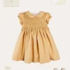 Pepa London Hand Smocked Peter Pan Collar Short Sleeve Dress in Beige (12mths-10yrs) | Openwork Cotton Cardigan in Cream (6mths-10yrs) | Mary Jane Leather Baby Shoes in Ivory (20-24EU) | Traditional Big Bow Tulle Hairband in Ivory | Celebration Short Socks with Ruffle- Cream (0mths-10yrs)