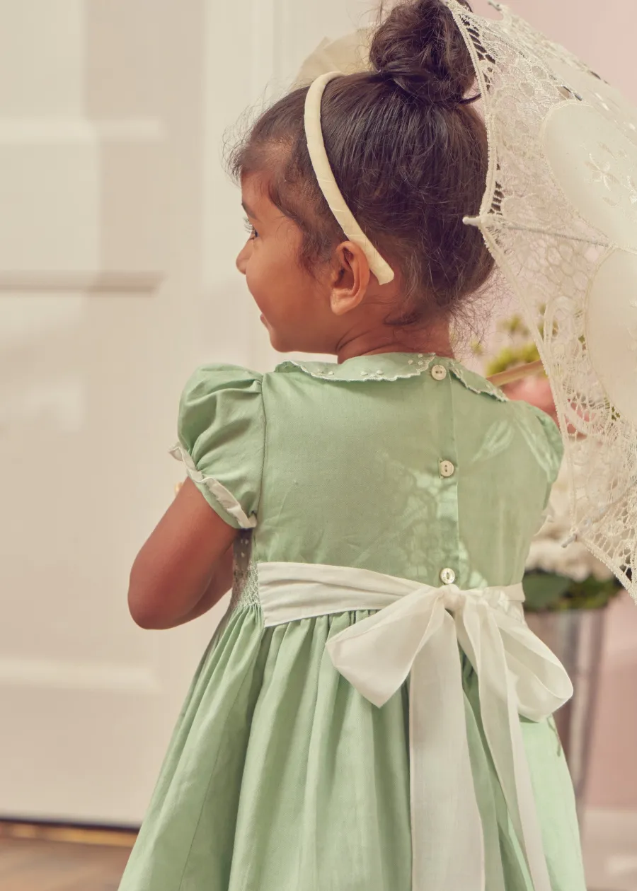 Pepa London Hand Smocked Peter Pan Collar Short Sleeve Dress in Green (12mths-10yrs) | Openwork Cotton Cardigan in Cream (6mths-10yrs) | Girls Ivory Leather Mary Jane Shoes (20-34EU) | Traditional Big Bow Tulle Hairband in Ivory | Flower Fairies of the Spring Book in White | Openwork short socks White (0mths-8yrs)