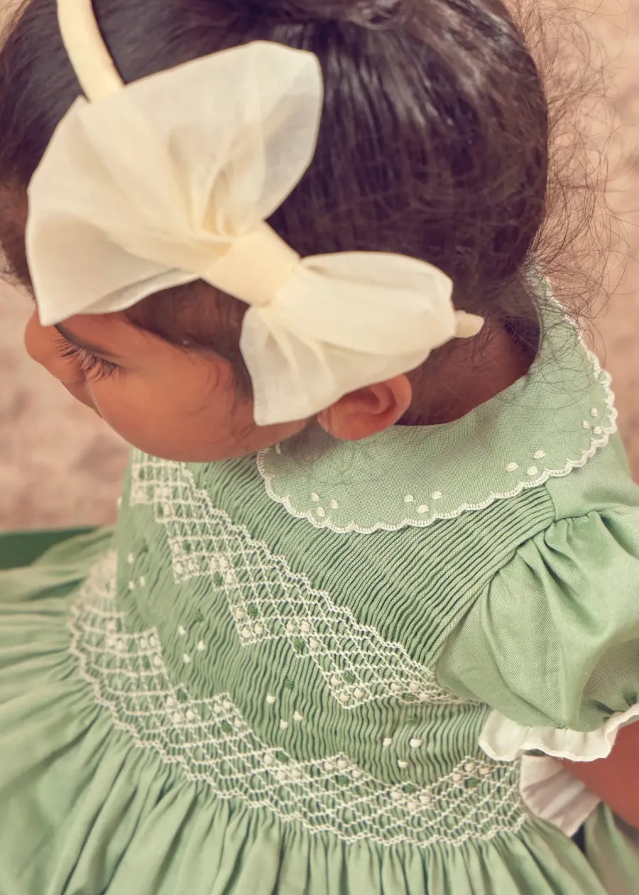 Pepa London Hand Smocked Peter Pan Collar Short Sleeve Dress in Green (12mths-10yrs) | Openwork Cotton Cardigan in Cream (6mths-10yrs) | Girls Ivory Leather Mary Jane Shoes (20-34EU) | Traditional Big Bow Tulle Hairband in Ivory | Flower Fairies of the Spring Book in White | Openwork short socks White (0mths-8yrs)