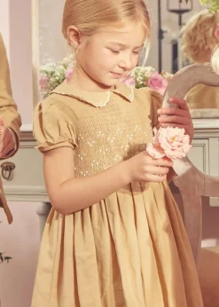 Pepa London Hand Smocked Peter Pan Collar Short Sleeve Dress in Beige (12mths-10yrs) | Openwork Cotton Cardigan in Cream (6mths-10yrs) | Mary Jane Leather Baby Shoes in Ivory (20-24EU) | Traditional Big Bow Tulle Hairband in Ivory | Celebration Short Socks with Ruffle- Cream (0mths-10yrs)