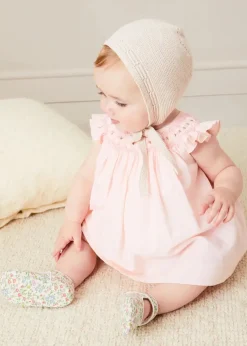 Pepa London Hand Smocked Sleeveless Dress With Bloomers in Pink (1-12mths) | Openwork Detail Baby Cardigan in Pink (1-12mths) | Openwork Knitted Bonnet in Beige(S-L) | Cordelia Liberty Floral Mary Jane Pram Shoes in Pink (17-20EU) | Cordelia Liberty Floral Dummy Clip in Pink | Knitted Bunny Teether in Beige | BIBS Dummy in Pink