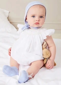 Pepa London Hand Smocked Sleeveless Romper in White (3-18mths) | Openwork Detail Baby Cardigan in Blue (1-12mths) | Lace Detail Knitted Bonnet in Blue (1-6mths) | Ellis Rounded Bib with Embroidery in Blue Made with Liberty Fabric | Lace Detail Knitted Booties in Blue | Ellis Dummy Clip in Blue Made with Liberty Fabric | My First Bunny in a Box - Blue | BIBS Dummy in Blue