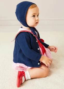 Pepa London Lawrence Striped Mariner Collar Short Sleeve Romper in Red (6mths-3yrs) | Openwork Knitted Bonnet in Navy (S-L) | Plain Cardigan in Navy (6mths-10yrs) | Leather Mary Jane Pram Shoes in Red (17-20EU) | Openwork short socks White (0mths-8yrs)