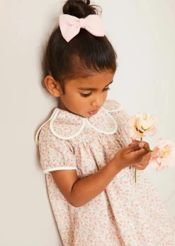 Pepa London Mabel Floral Statement Collar Short Sleeve Dress in Coral (12mths-10yrs) | Plain Cardigan in Cream (6mths-10yrs) | Mary Jane Baby Shoes in Pink (20-26EU) | Mabel Floral Hairband in Coral | Openwork short socks White (0mths-8yrs)