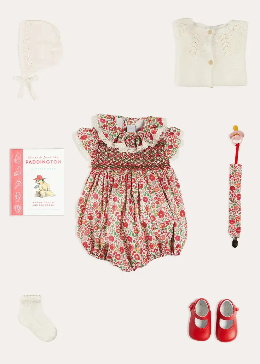 Pepa London Margot Floral Romper in Red Made with Liberty Fabric (6m-2yrs) | Openwork Cotton Cardigan in Cream (6mths-10yrs) | Openwork Cotton Knitted Bonnet in Cream (S-L) | Leather Mary Jane Pram Shoes in Red (17-20EU) | Margot Dummy Clip in Red Made with Liberty Fabric | Openwork short socks White (0mths-8yrs) | BIBS Dummy in Pink