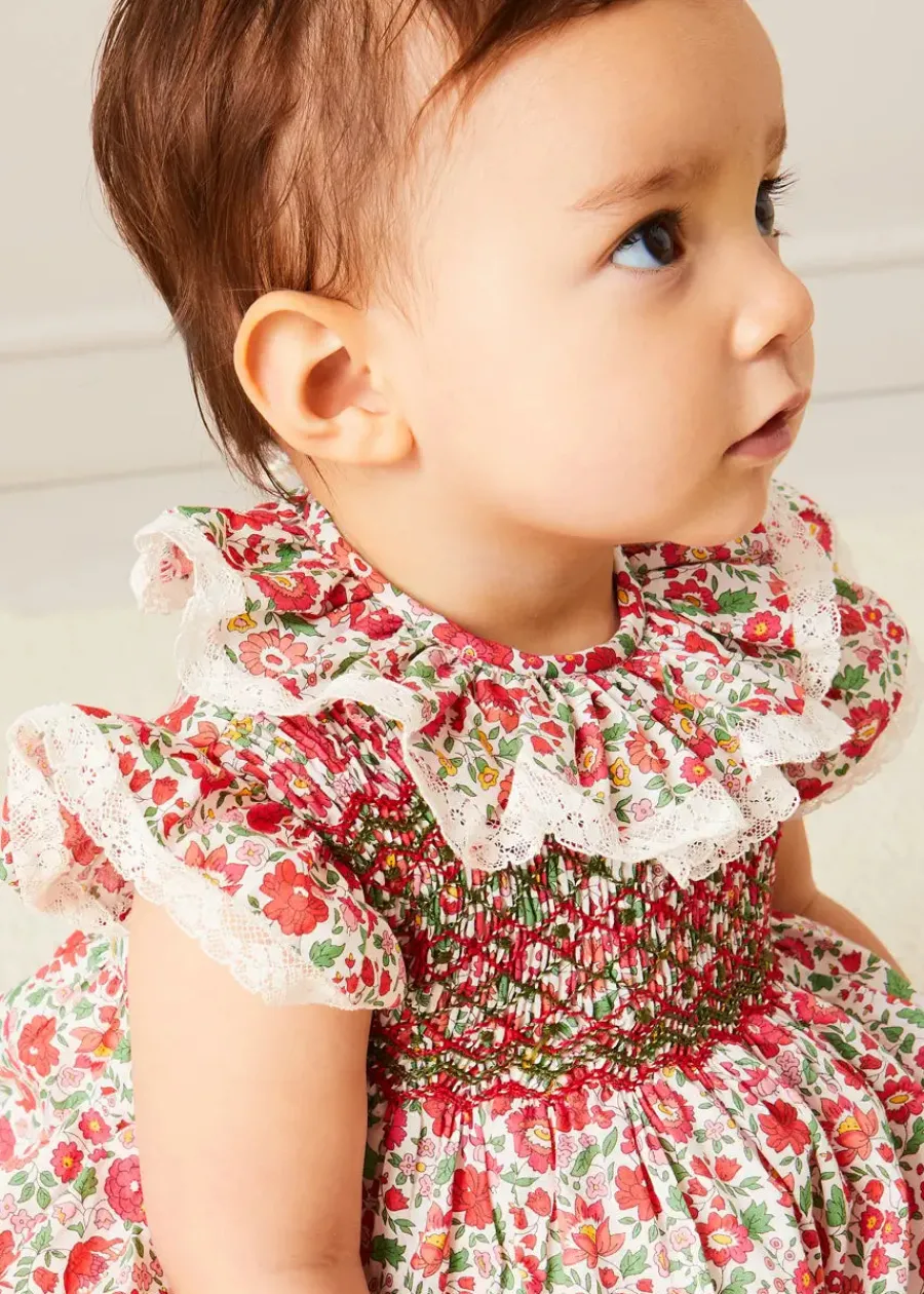 Pepa London Margot Floral Romper in Red Made with Liberty Fabric (6m-2yrs) | Openwork Cotton Cardigan in Cream (6mths-10yrs) | Openwork Cotton Knitted Bonnet in Cream (S-L) | Leather Mary Jane Pram Shoes in Red (17-20EU) | Margot Dummy Clip in Red Made with Liberty Fabric | Openwork short socks White (0mths-8yrs) | BIBS Dummy in Pink