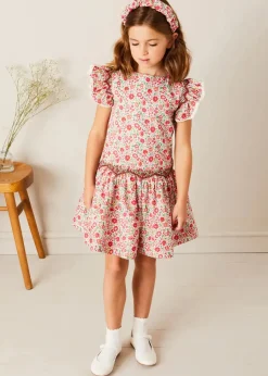 Pepa London Margot Floral Sleeveless Hand-Smocked Dress in Red Made with Liberty Fabric (4-12yrs) | Openwork Cotton Cardigan in Cream (6mths-10yrs) | Girls Ivory Leather Mary Jane Shoes (20-34EU) | Margot Liberty Floral Scrunchie Hairband in Red | Openwork short socks White (0mths-8yrs)