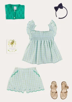 Pepa London Maxwell Gingham Smock Detail Blouse in Green (5-10yrs) | Maxwell Gingham Scallop Trim Embroidered Shorts in Green (18mths-10yrs) | Floral Openwork Cotton Cardigan in Green (2-10yrs) | Leather Woven Detail Sandals in Beige (24-35EU) | Navy Linen Big Bow Hairband | Flower Fairies of the Spring Book in White