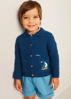 BOY Pepa London Nautical Boat Embroidery Polo Collar Cardigan in Blue (12mths-6yrs) | Chesham Striped Mao Collar Long Sleeve Shirt in Red (3-10yrs) | Plain Elasticated Shorts in Blue (12mths-4yrs) | T-Bar Baby Shoes in Blue (20-26EU) | Ribbed Short Socks in Beige (0mths-10yrs)