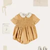 BOY Pepa London Peter Pan Collar Hand Smocked Short Sleeve Romper in Camel (6mths-2yrs) | Plain Cardigan in Cream (6mths-10yrs) | Openwork Knitted Bonnet in Beige(S-L) | T-Bar Leather Pram Shoes in Ivory (17-20EU) | Cotton Short Socks Cream (0mths-10yrs)