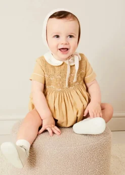 BOY Pepa London Peter Pan Collar Hand Smocked Short Sleeve Romper in Camel (6mths-2yrs) | Plain Cardigan in Cream (6mths-10yrs) | Openwork Knitted Bonnet in Beige(S-L) | T-Bar Leather Pram Shoes in Ivory (17-20EU) | Cotton Short Socks Cream (0mths-10yrs)