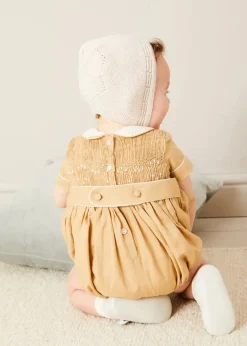 BOY Pepa London Peter Pan Collar Hand Smocked Short Sleeve Romper in Camel (6mths-2yrs) | Plain Cardigan in Cream (6mths-10yrs) | Openwork Knitted Bonnet in Beige(S-L) | T-Bar Leather Pram Shoes in Ivory (17-20EU) | Cotton Short Socks Cream (0mths-10yrs)
