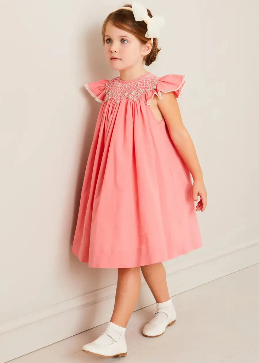 Pepa London Plain Hand Smocked Sleeveless Dress in Coral (12mths-10yrs) | Plain Cardigan in Cream (6mths-10yrs) | Girls Ivory Leather Mary Jane Shoes (20-34EU) | Traditional Big Bow Tulle Hairband in Ivory | Openwork short socks White (0mths-8yrs)