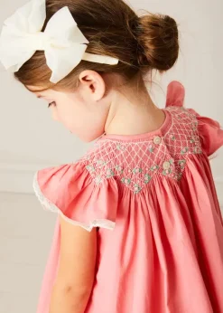 Pepa London Plain Hand Smocked Sleeveless Dress in Coral (12mths-10yrs) | Plain Cardigan in Cream (6mths-10yrs) | Girls Ivory Leather Mary Jane Shoes (20-34EU) | Traditional Big Bow Tulle Hairband in Ivory | Openwork short socks White (0mths-8yrs)