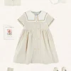 Pepa London Waterford Striped Mariner Collar Double Breasted Short Sleeve Dress in Beige (12mths-10yrs) | Openwork Cotton Cardigan in Cream (6mths-10yrs) | Girl's Beige Leather Celebration Shoes (20-34EU) | Tulle Long Bow Clip In Cream | Cotton Short Socks Cream (0mths-10yrs)