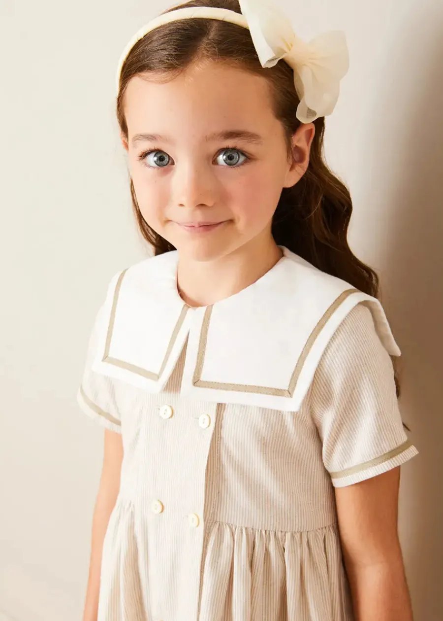 Pepa London Waterford Striped Mariner Collar Double Breasted Short Sleeve Dress in Beige (12mths-10yrs) | Openwork Cotton Cardigan in Cream (6mths-10yrs) | Girl's Beige Leather Celebration Shoes (20-34EU) | Tulle Long Bow Clip In Cream | Cotton Short Socks Cream (0mths-10yrs)